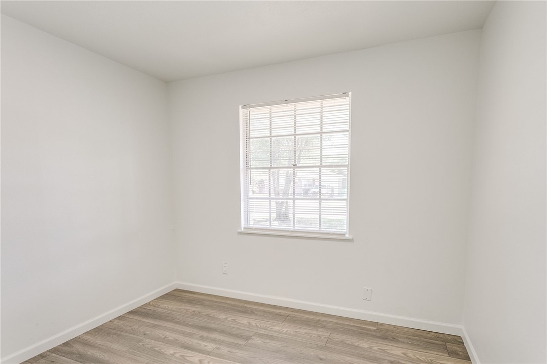 3029 S Madole Boulevard, Oklahoma City, OK 73159 wood floored spare room featuring natural light