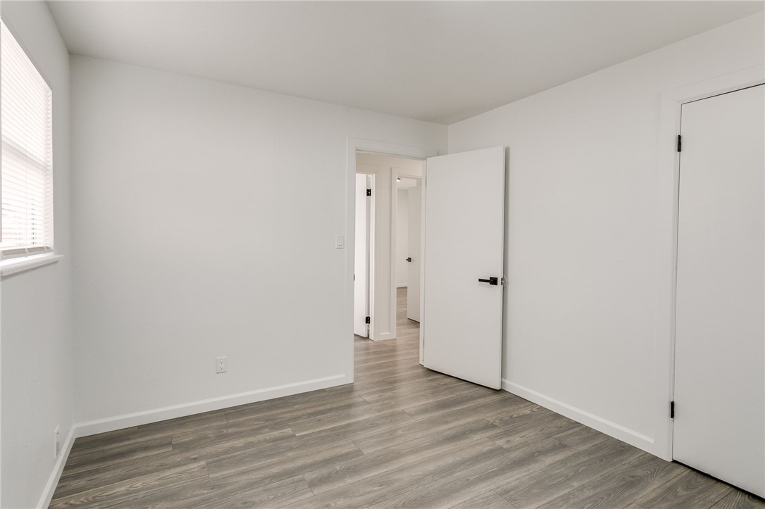 3029 S Madole Boulevard, Oklahoma City, OK 73159 hardwood floored bedroom with natural light