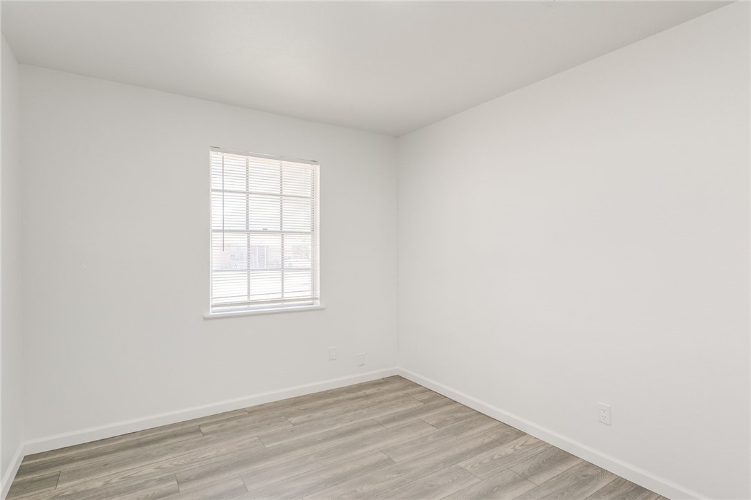 3029 S Madole Boulevard, Oklahoma City, OK 73159 wood floored empty room with natural light