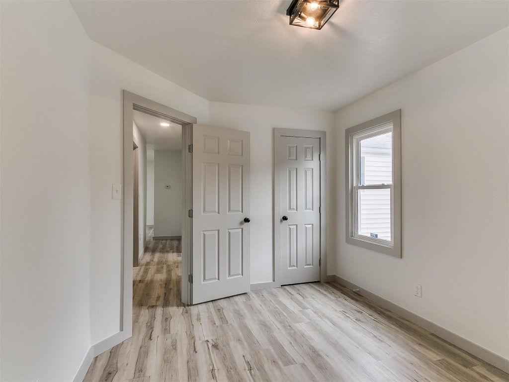 1408 N Elm Street, Guthrie, OK 73044 bedroom with hardwood floors and natural light