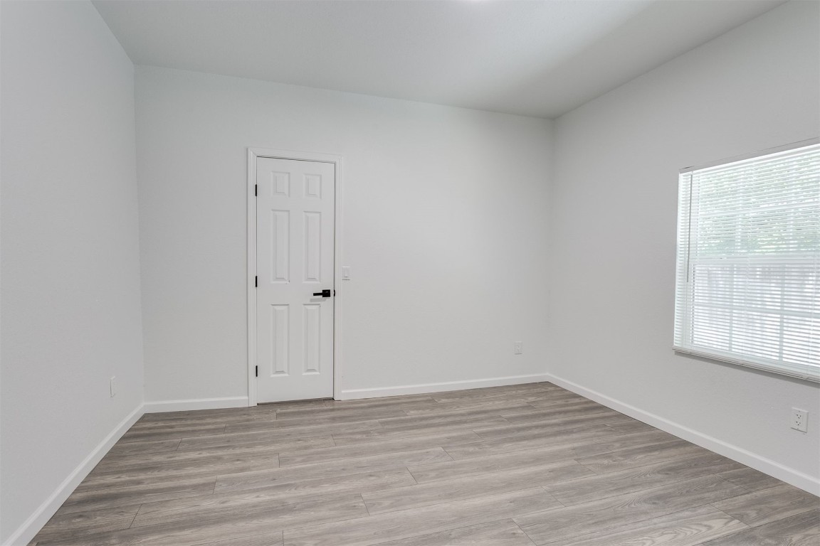 615 E Gray Street, Norman, OK 73071 empty room with hardwood floors and natural light