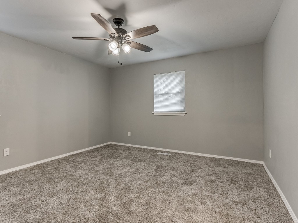 608 SW 26th Street, El Reno, OK 73036 spare room featuring a ceiling fan, carpet, and natural light