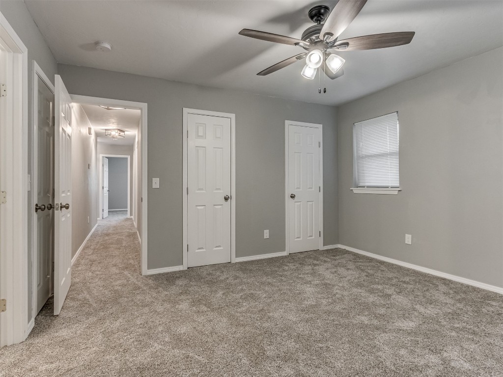 608 SW 26th Street, El Reno, OK 73036 bedroom featuring a ceiling fan, carpet, and natural light