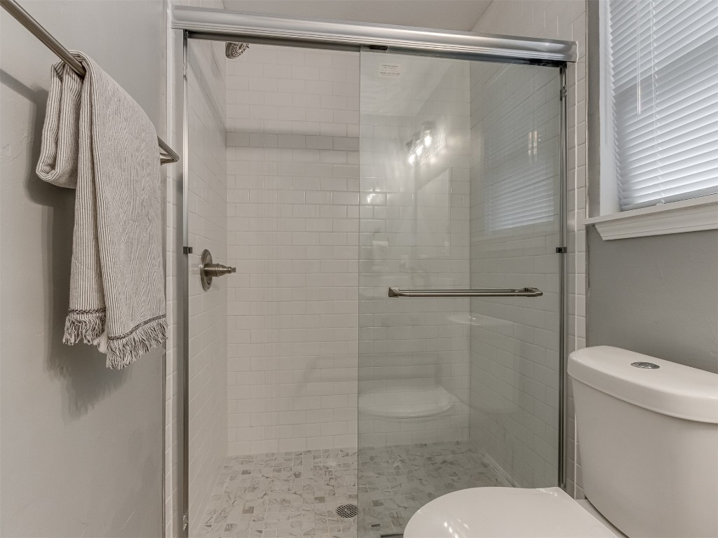 608 SW 26th Street, El Reno, OK 73036 bathroom featuring tile floors, toilet, and shower with glass door