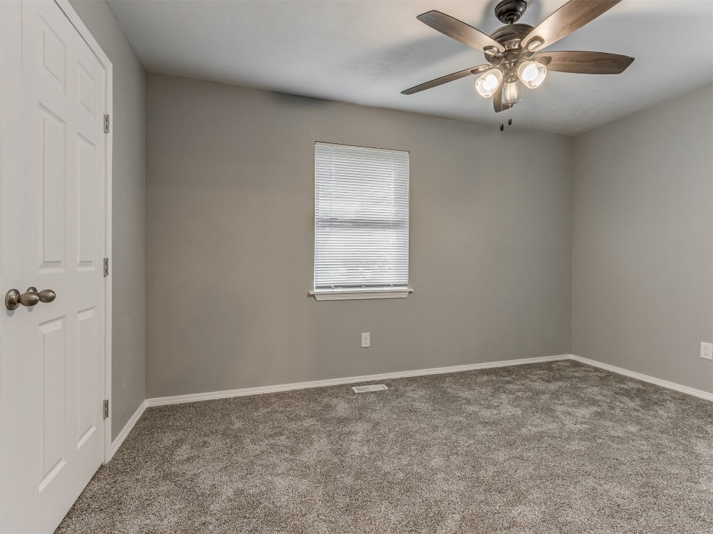 608 SW 26th Street, El Reno, OK 73036 carpeted empty room featuring a ceiling fan and natural light