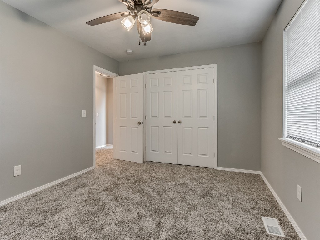 608 SW 26th Street, El Reno, OK 73036 carpeted bedroom featuring a ceiling fan