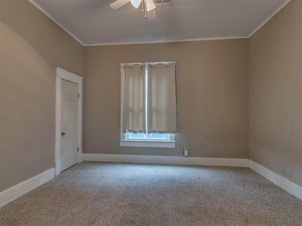 717 N Market Avenue, Shawnee, OK 74801 spare room with a ceiling fan and carpet