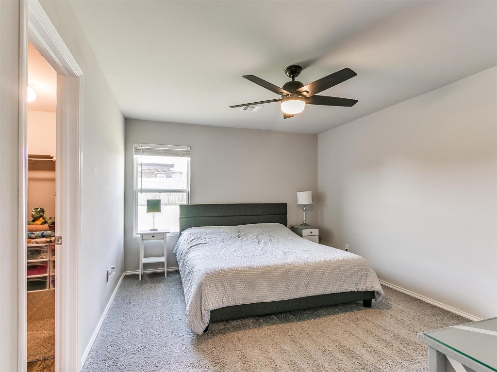9521 NW 121st Street, Yukon, OK 73099 bedroom featuring natural light, a ceiling fan, and carpet