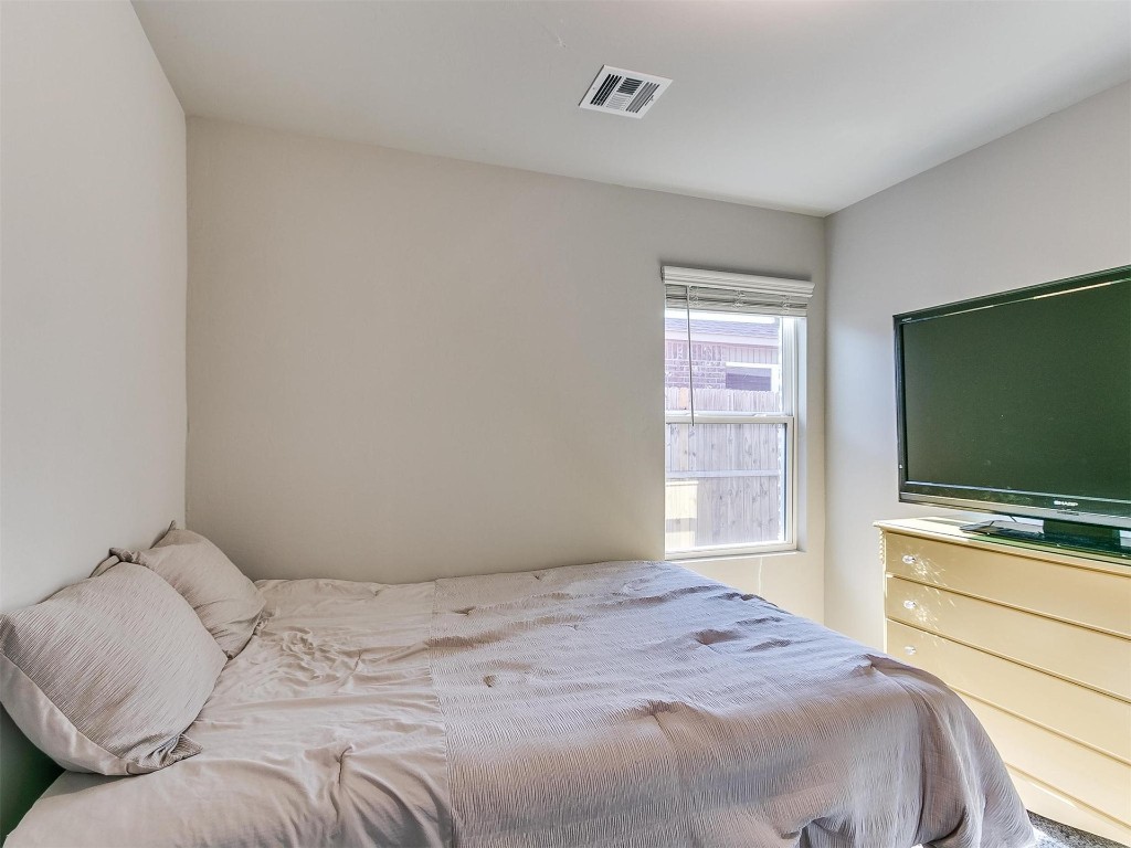 9521 NW 121st Street, Yukon, OK 73099 bedroom featuring natural light and TV