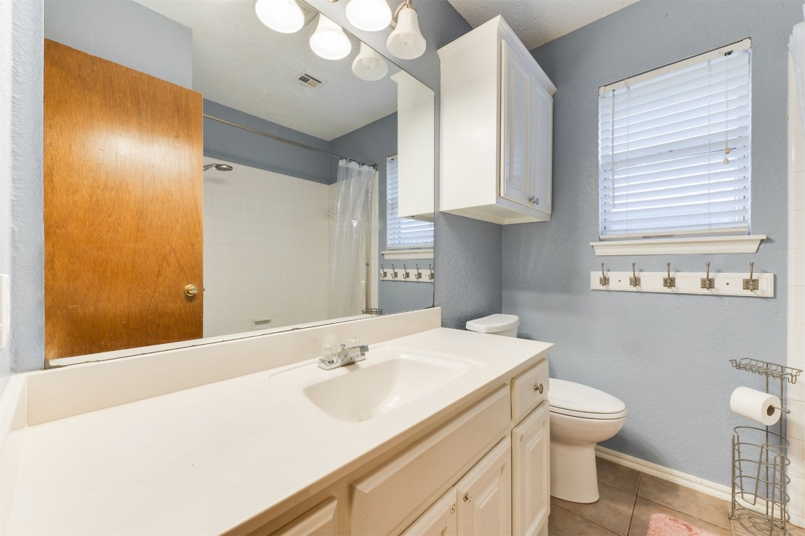 9306 Buttonfield Avenue, Moore, OK 73160 bathroom with tile flooring, oversized vanity, and toilet
