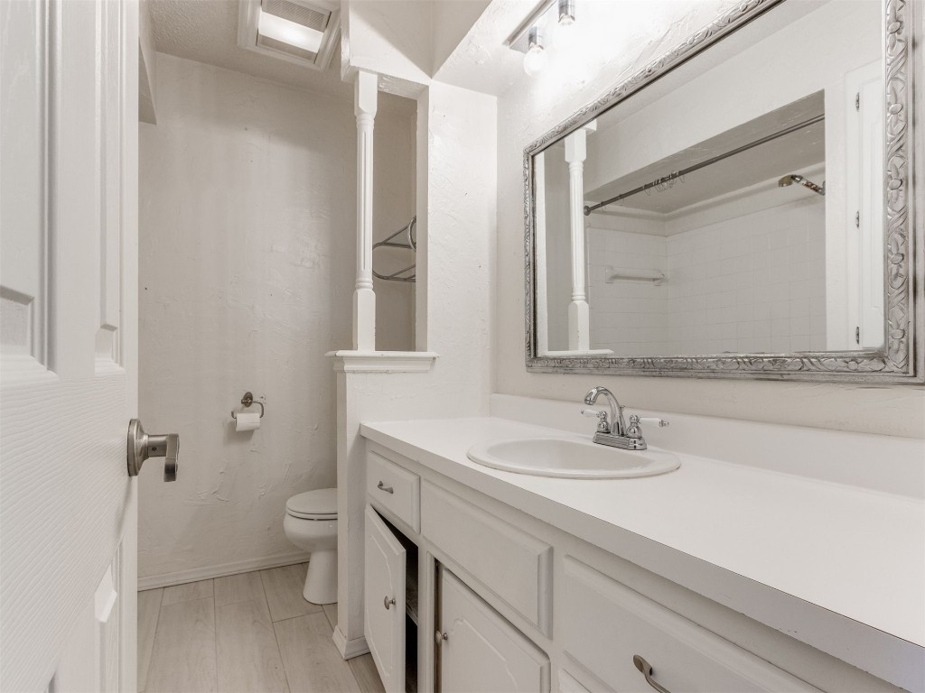 716 Lonnie Lane, Moore, OK 73170 bathroom featuring mirror, vanity, and light parquet floors