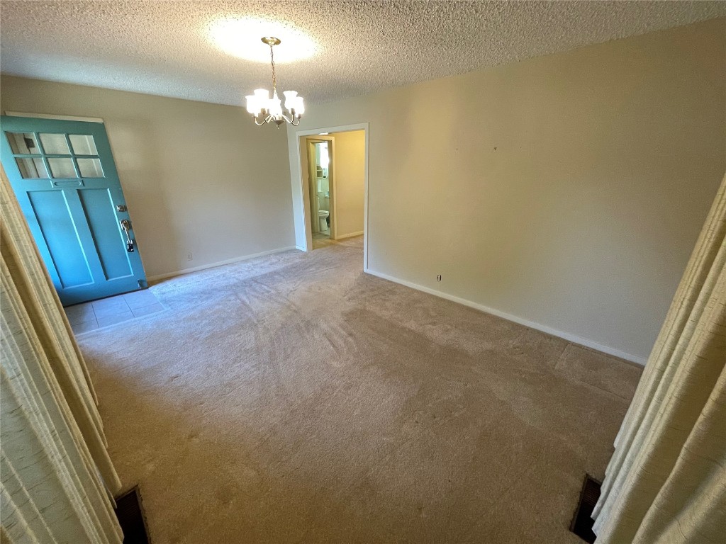 1815 Park Avenue, Chickasha, OK 73067-4505 carpeted empty room featuring a textured ceiling