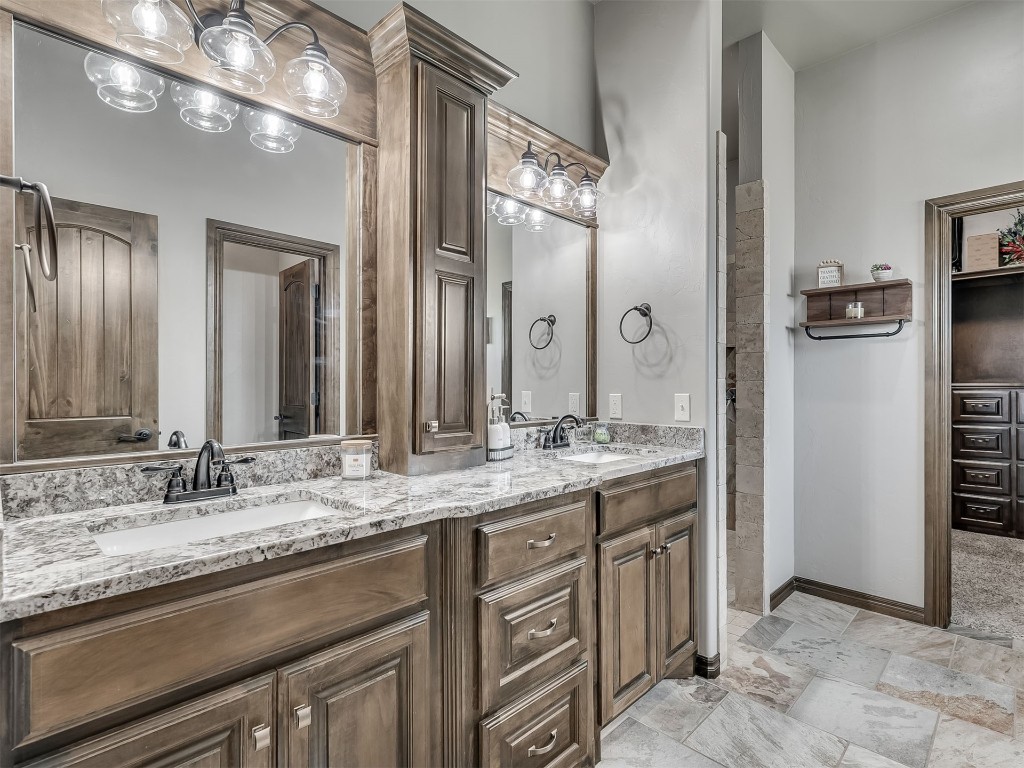 1123 S Czech Hall Road, Tuttle, OK 73089 bathroom with double sink vanity, mirror, and light tile floors