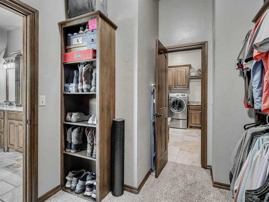 1123 S Czech Hall Road, Tuttle, OK 73089 walk in closet with light carpet and washer / clothes dryer