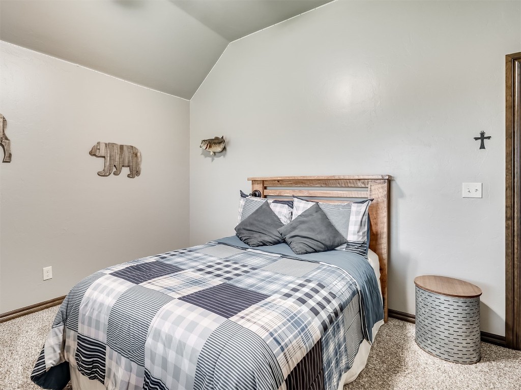 1123 S Czech Hall Road, Tuttle, OK 73089 carpeted bedroom featuring vaulted ceiling