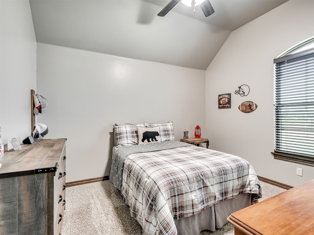 1123 S Czech Hall Road, Tuttle, OK 73089 bedroom with light carpet, lofted ceiling, and ceiling fan