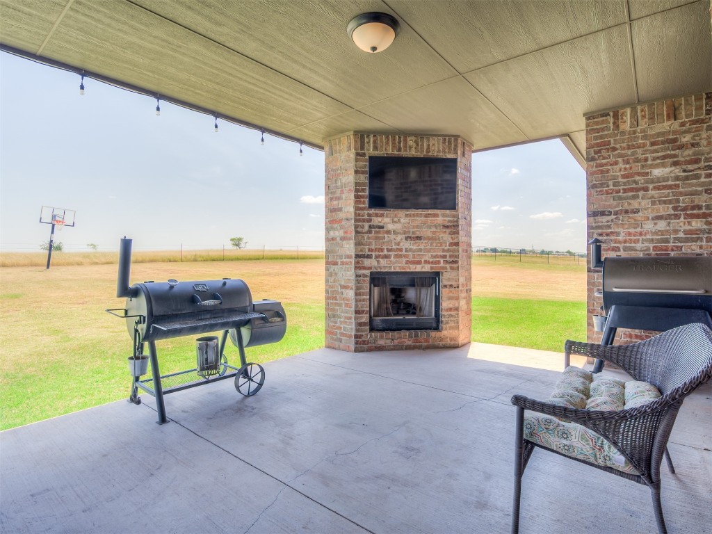 1123 S Czech Hall Road, Tuttle, OK 73089 view of terrace featuring an outdoor fireplace