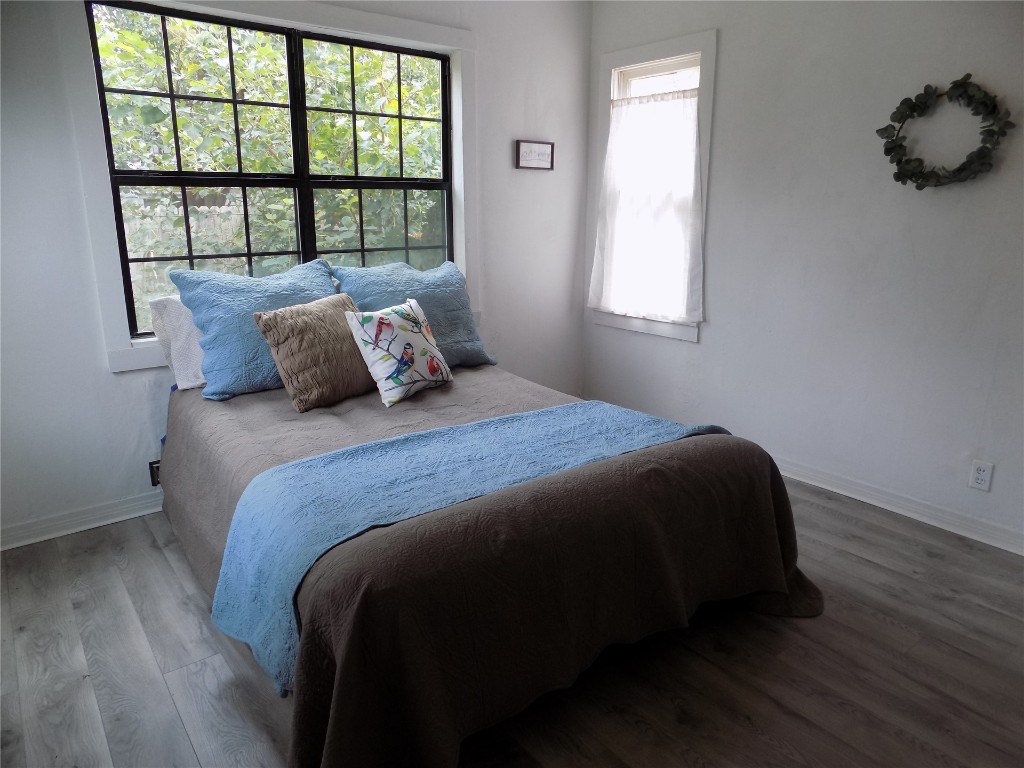 2402 Townsend Drive, El Reno, OK 73036 bedroom with multiple windows and light hardwood flooring