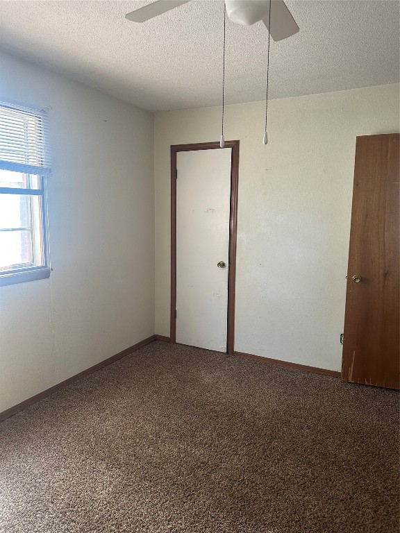 7804 S Charlotte Drive, Oklahoma City, OK 73159 carpeted spare room with a textured ceiling and ceiling fan