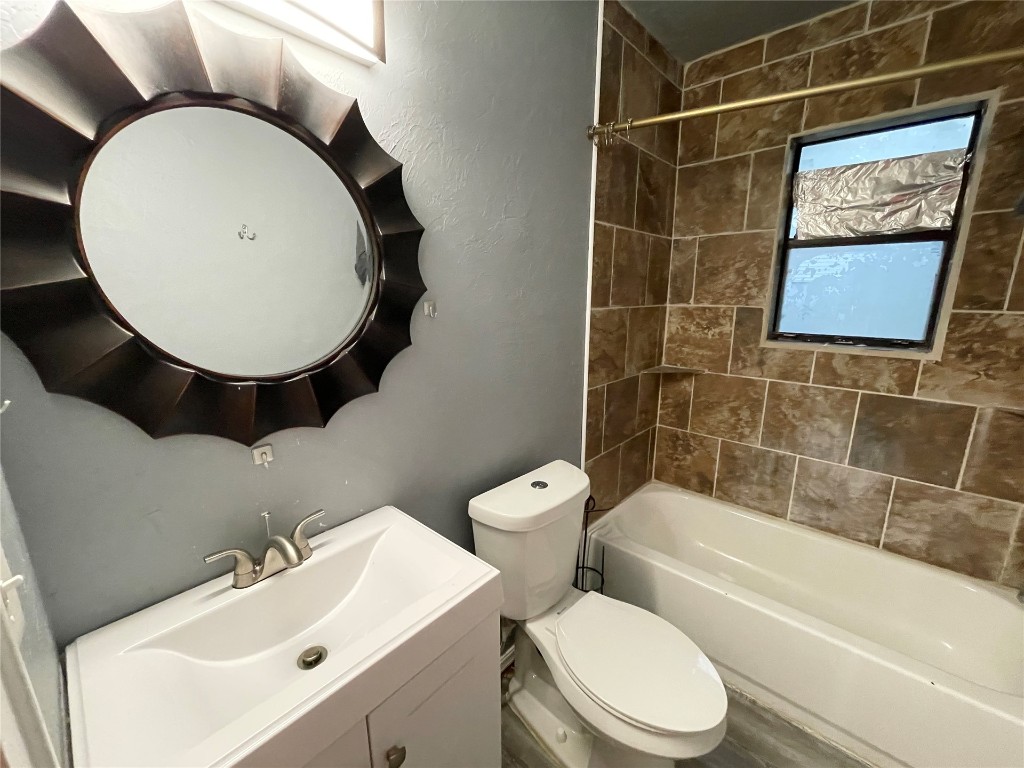 2221 NW 13th Street, Oklahoma City, OK 73107 full bathroom with oversized vanity, tiled shower / bath, and mirror