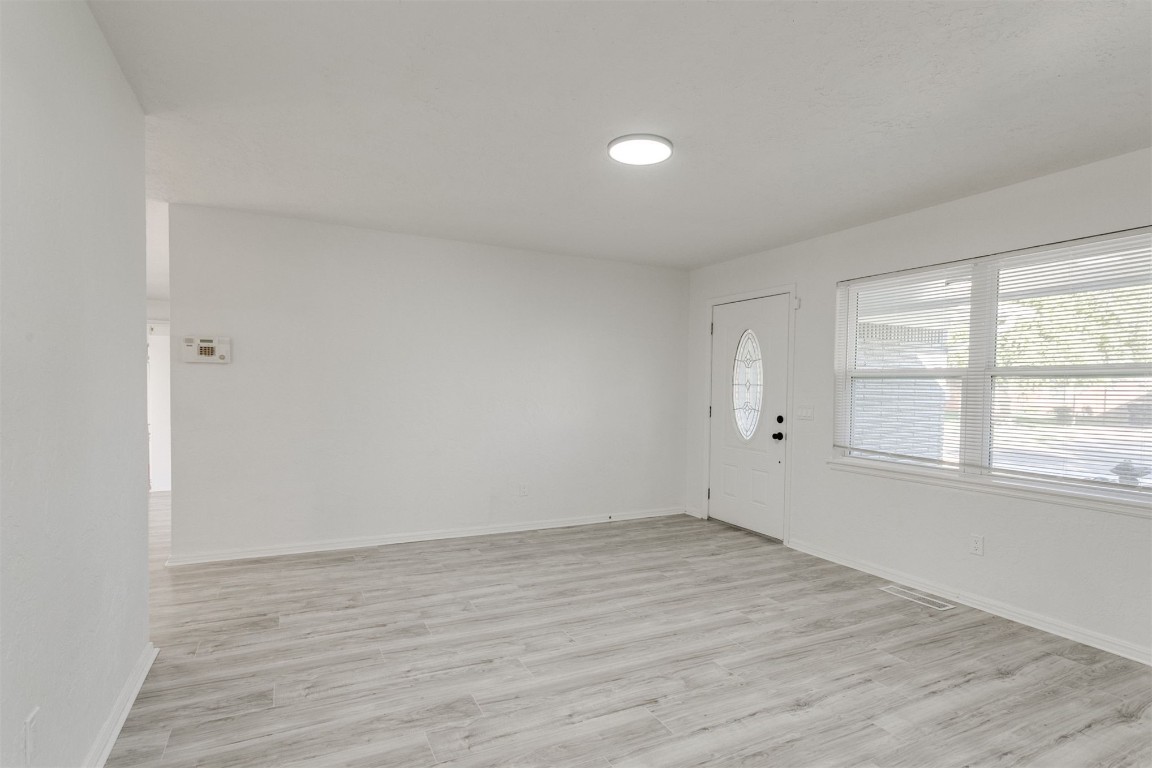 2600 SW 65th Street, Oklahoma City, OK 73159 wood floored spare room with a healthy amount of sunlight