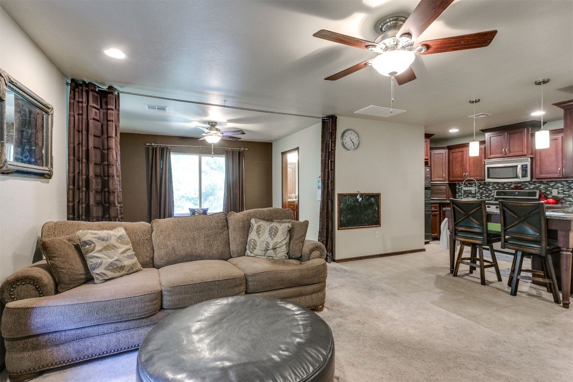 3324 Oakbriar Drive, Choctaw, OK 73020 carpeted living room with ceiling fan