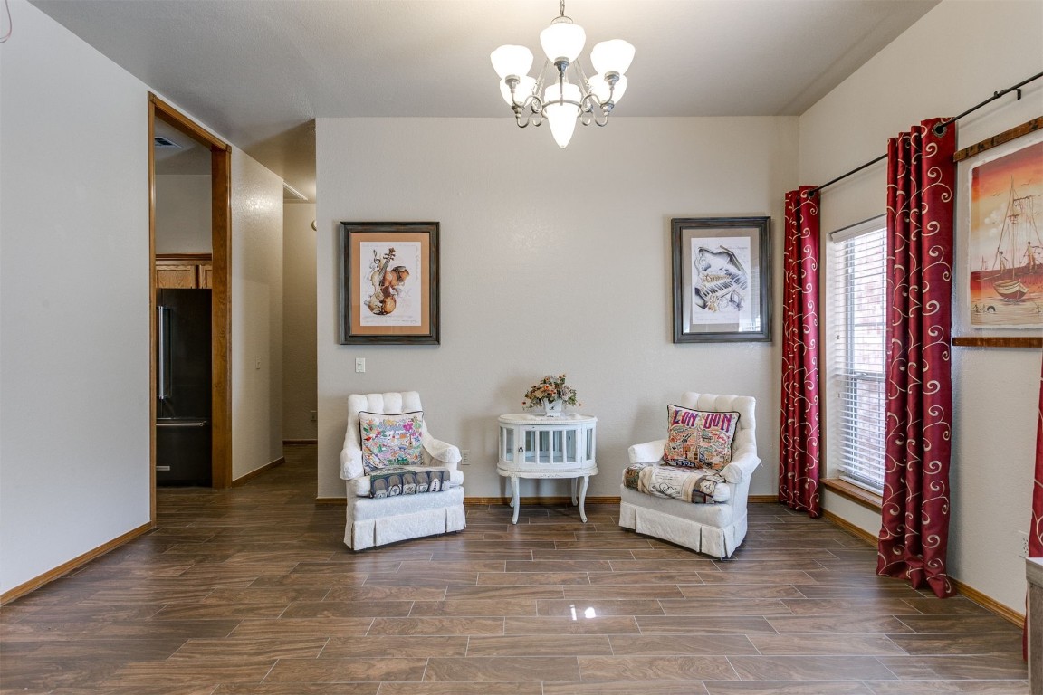 3324 Oakbriar Drive, Choctaw, OK 73020 living area featuring a notable chandelier and wood-type flooring