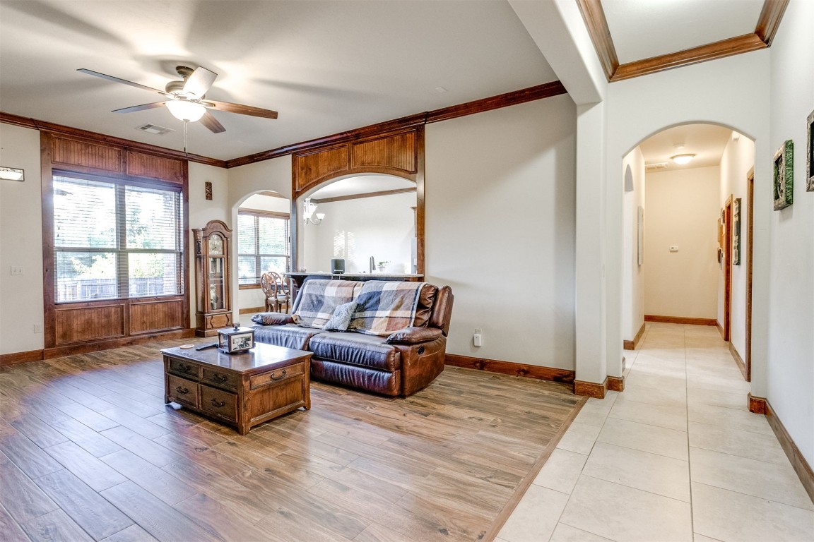 2901 Morgan Trace Road, Yukon, OK 73099 living room with crown molding, ceiling fan, and light hardwood / wood-style flooring