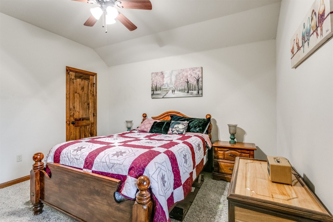 2901 Morgan Trace Road, Yukon, OK 73099 carpeted bedroom with ceiling fan and vaulted ceiling