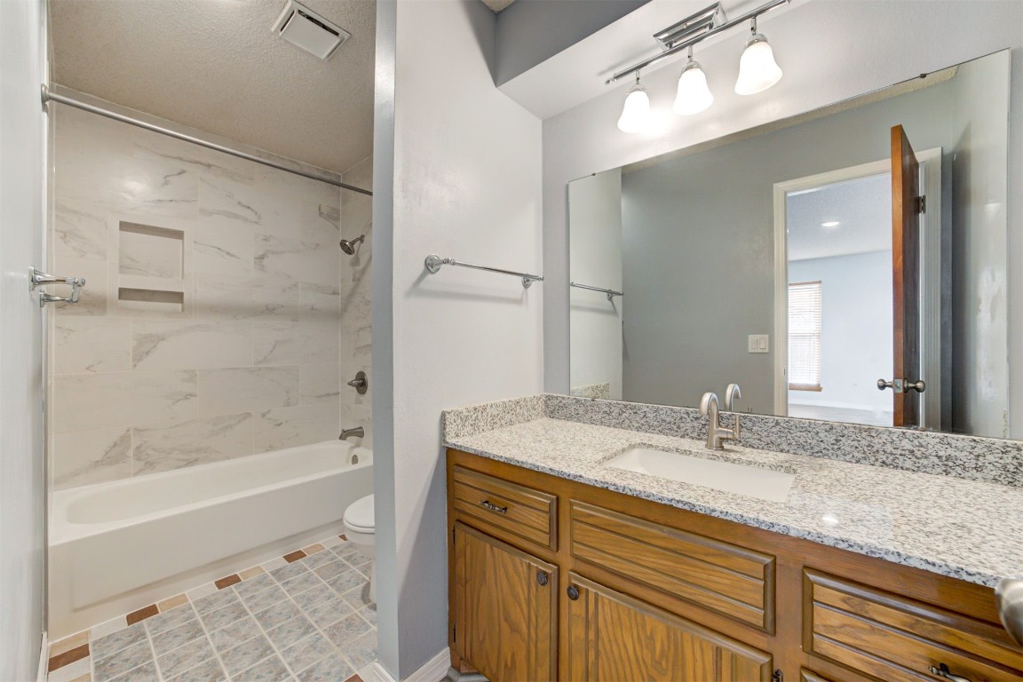 633 Westridge Court, Yukon, OK 73099 full bathroom featuring vanity, toilet, tile flooring, and tiled shower / bath