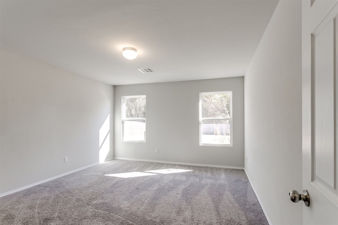10708 SW 23rd Place, Yukon, OK 73099 carpeted spare room featuring a healthy amount of sunlight