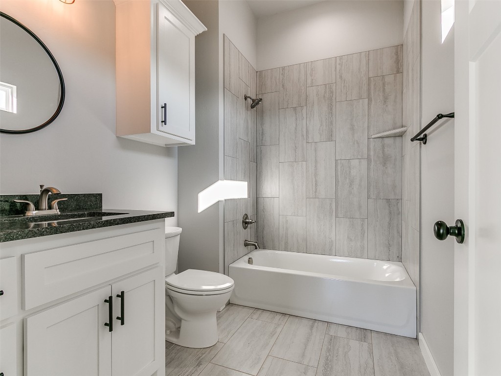 117 W Duane Drive, Mustang, OK 73064 full bathroom with toilet, tiled shower / bath combo, tile floors, and vanity