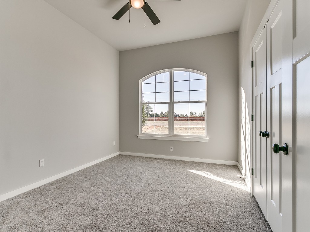 117 W Duane Drive, Mustang, OK 73064 unfurnished room with ceiling fan and light carpet