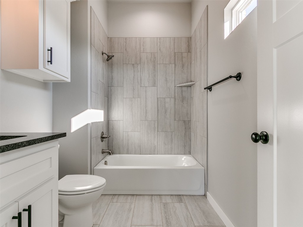 117 W Duane Drive, Mustang, OK 73064 full bathroom featuring tiled shower / bath, vanity, toilet, and tile floors