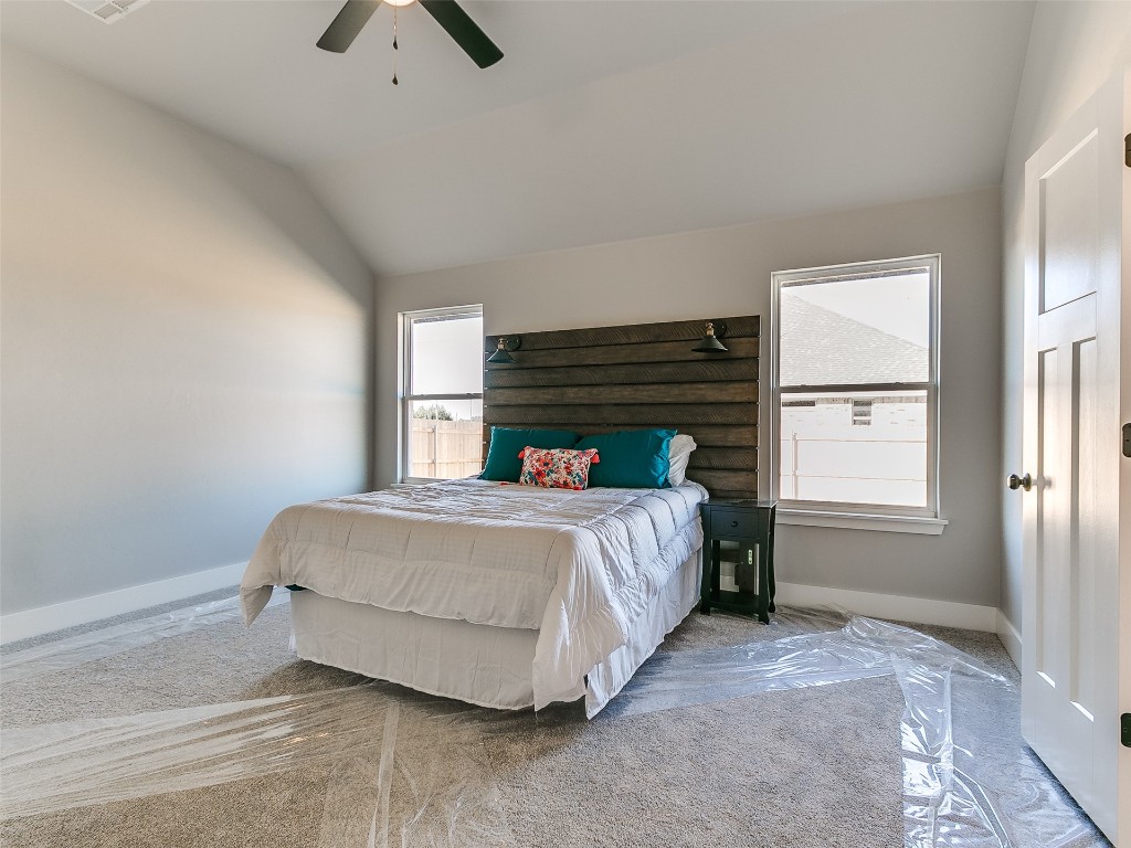 117 W Duane Drive, Mustang, OK 73064 carpeted bedroom with ceiling fan and vaulted ceiling