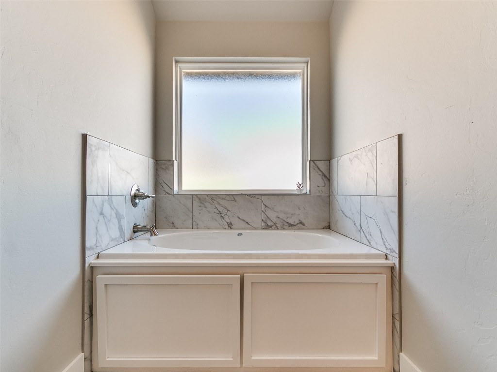 117 W Duane Drive, Mustang, OK 73064 bathroom featuring a tub and a healthy amount of sunlight