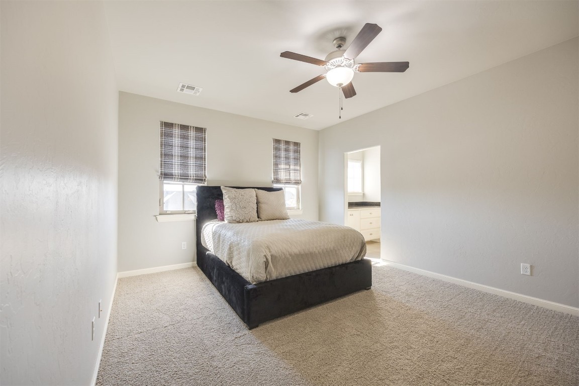 6332 Wentworth Drive, Edmond, OK 73025 bedroom featuring light carpet and ceiling fan