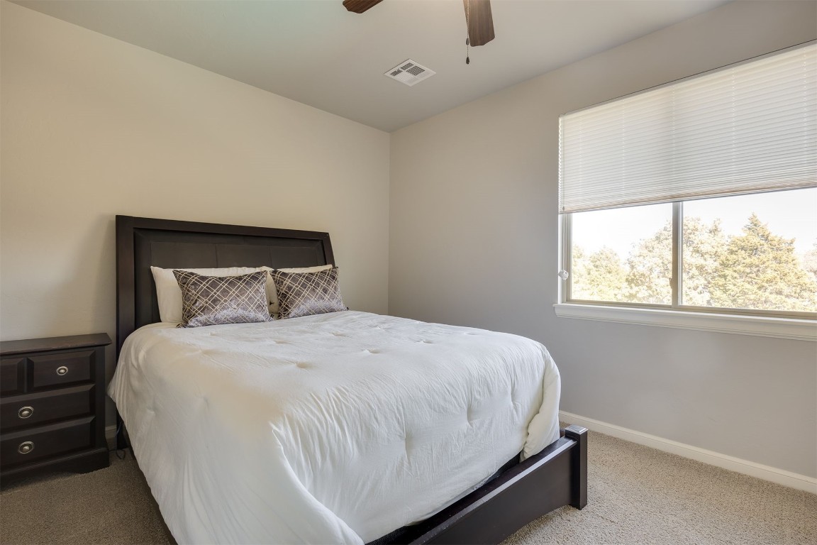 6332 Wentworth Drive, Edmond, OK 73025 carpeted bedroom featuring ceiling fan