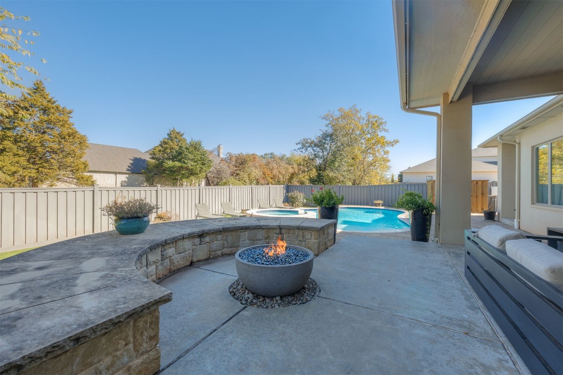 6332 Wentworth Drive, Edmond, OK 73025 view of patio featuring an outdoor fire pit and a pool with hot tub