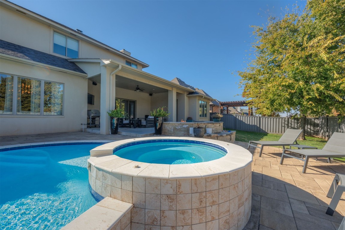 6332 Wentworth Drive, Edmond, OK 73025 view of pool with ceiling fan, a patio area, an in ground hot tub, and a grill
