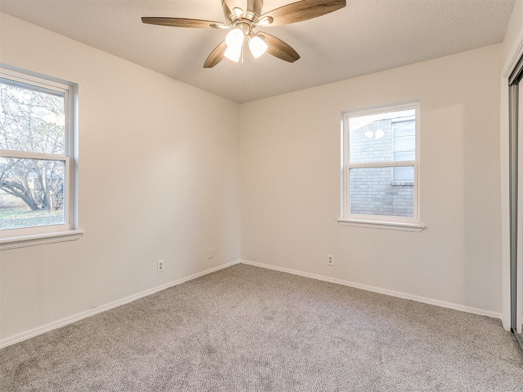 813 S Meadow Lane, Mustang, OK 73064 carpeted spare room featuring ceiling fan