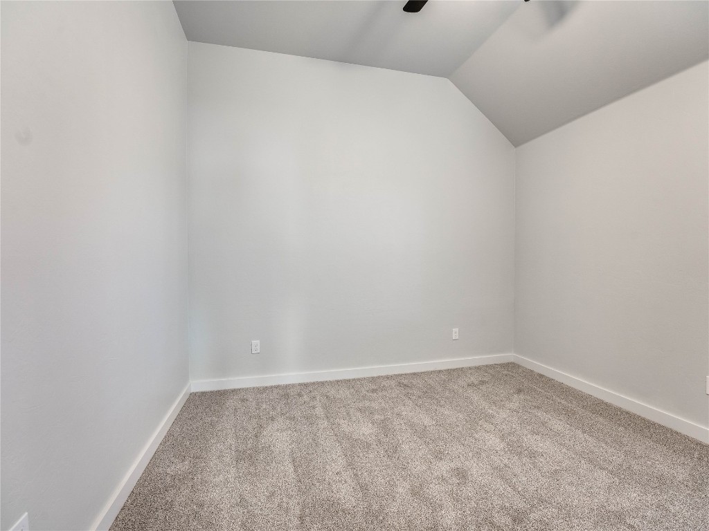 124 W Lynn Court Drive, Mustang, OK 73064 carpeted empty room with lofted ceiling