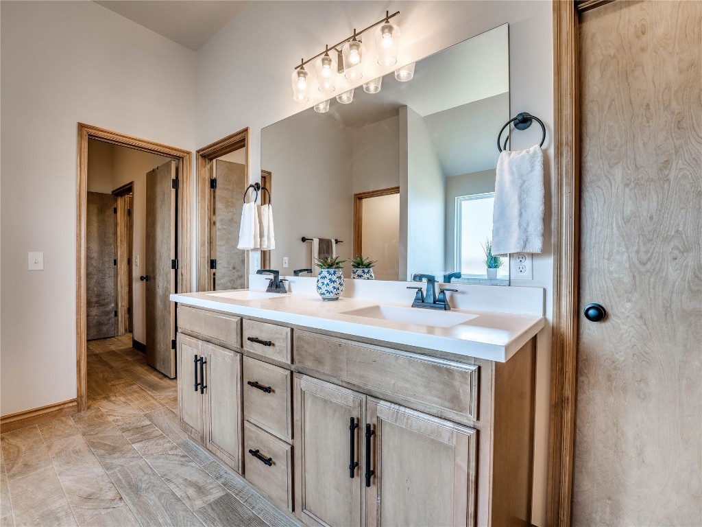 10517 NW 33rd Street, Yukon, OK 73099 bathroom featuring tile floors and dual bowl vanity