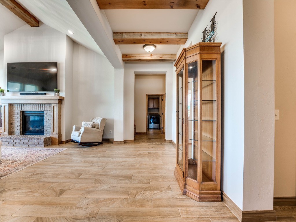 10517 NW 33rd Street, Yukon, OK 73099 corridor with beam ceiling and light hardwood / wood-style flooring