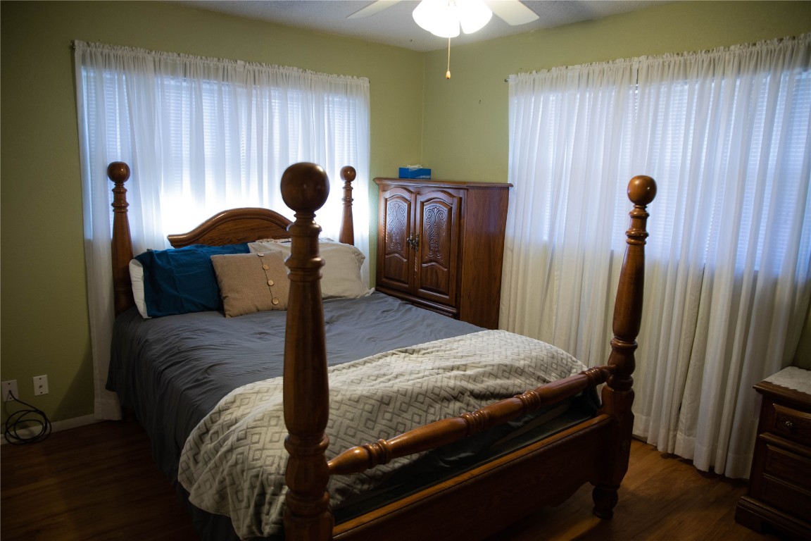 107 Cimarron Road, Burns Flat, OK 73647 bedroom featuring dark hardwood / wood-style floors and ceiling fan