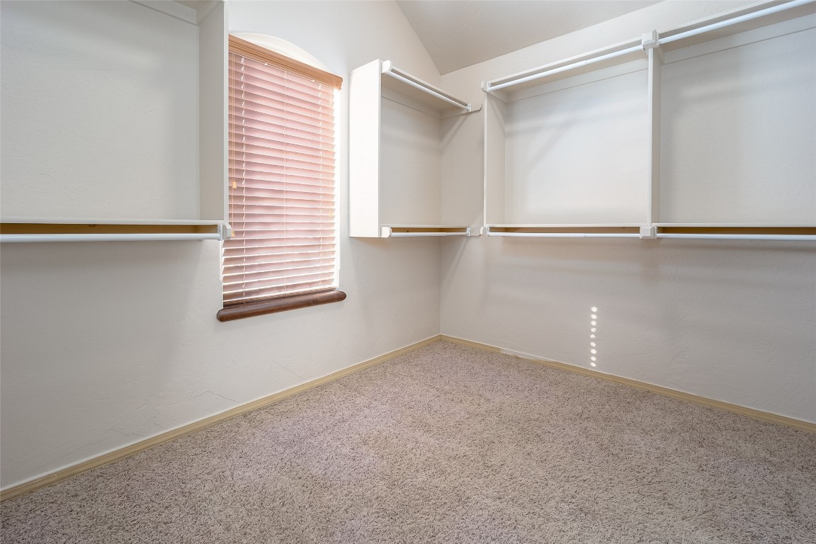 8509 NW 111th Street, Oklahoma City, OK 73162 spacious closet featuring lofted ceiling and light carpet