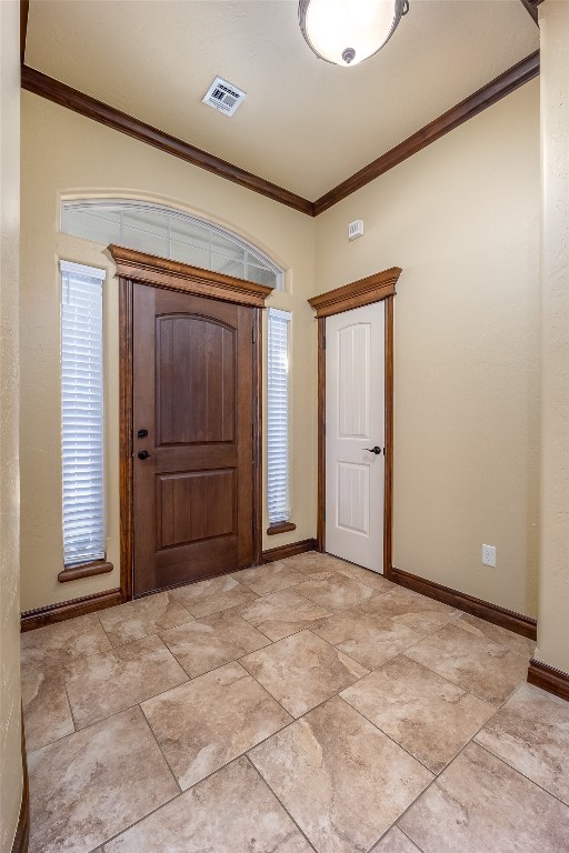 8509 NW 111th Street, Oklahoma City, OK 73162 foyer entrance with ornamental molding and light tile flooring