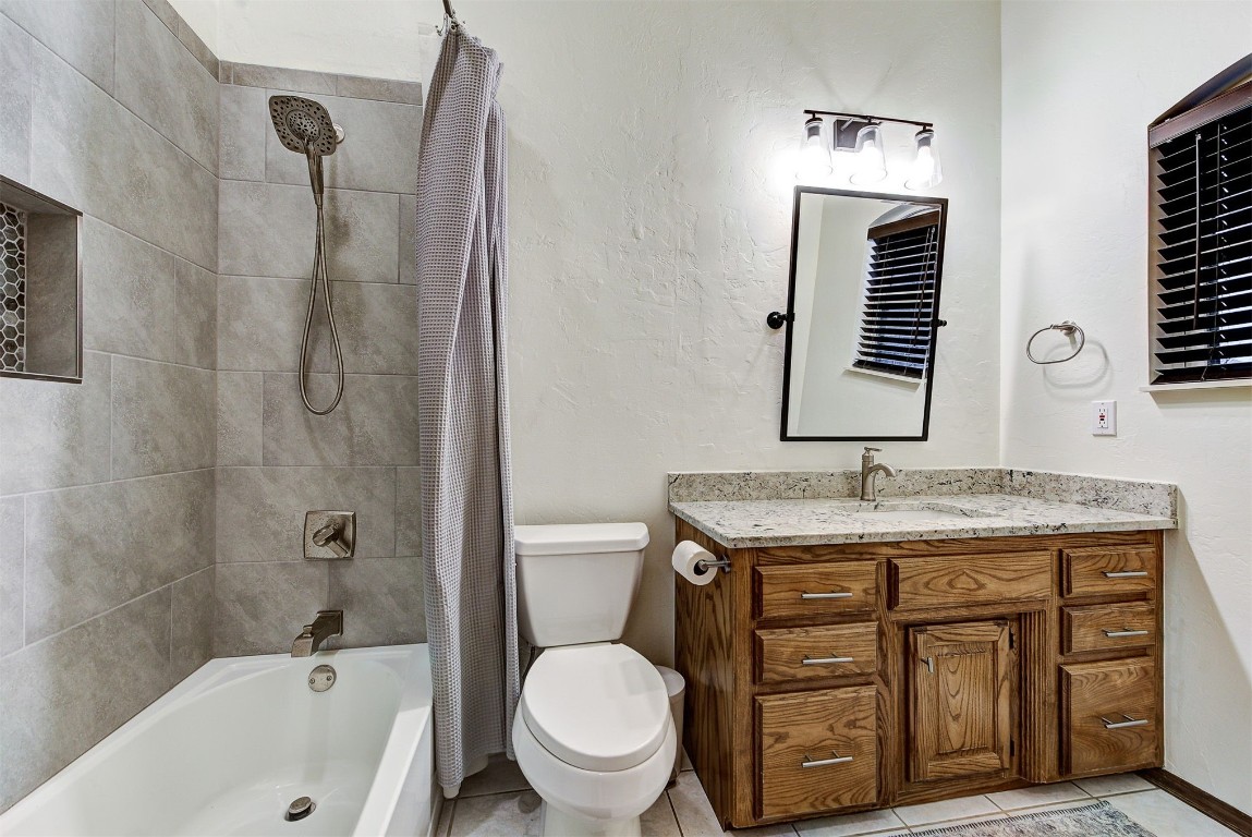1304 Polly Way, Mustang, OK 73064 full bathroom featuring shower / bath combination with curtain, tile flooring, toilet, and vanity
