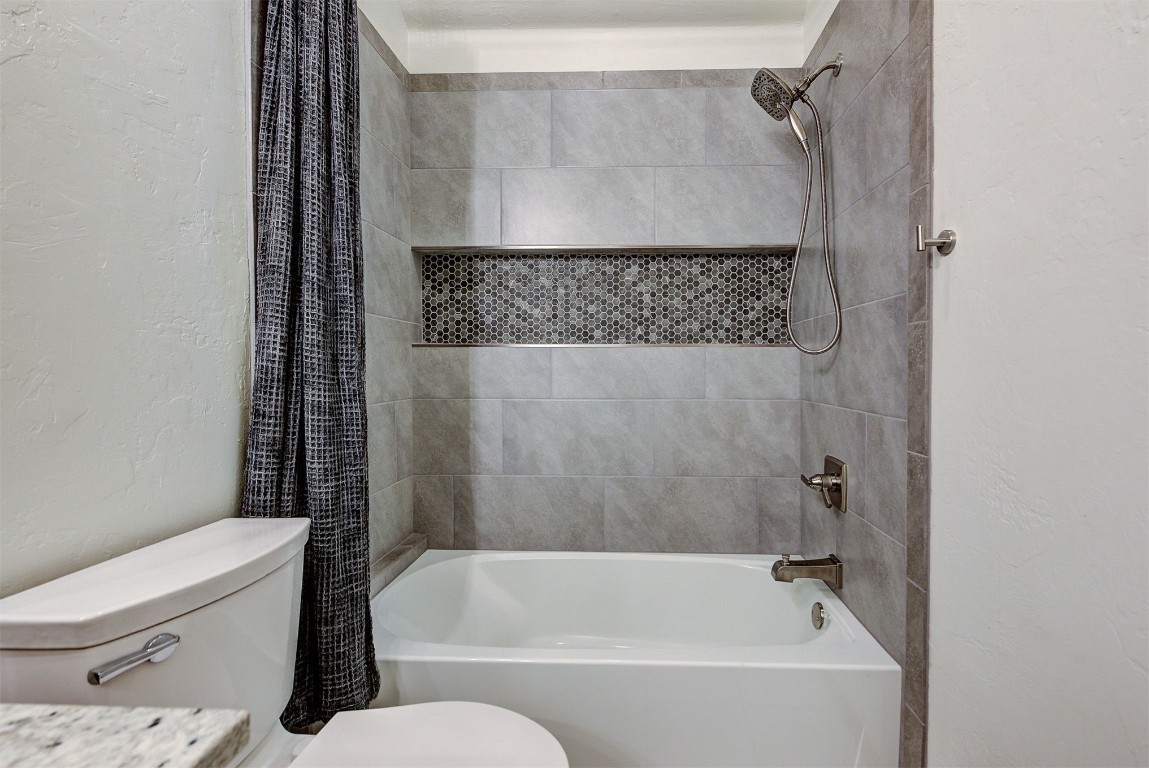 1304 Polly Way, Mustang, OK 73064 full bathroom featuring vanity, shower / bath combo with shower curtain, and toilet