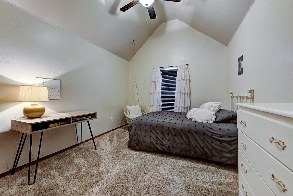 1304 Polly Way, Mustang, OK 73064 carpeted bedroom featuring lofted ceiling and ceiling fan